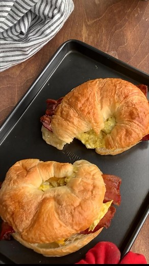 These Croissant Breakfast Sandwiches are everything you want in a morning bite 🥐🍳 Buttery croissants, melty cheese, eggs, and your favorite breakfast meat—easy to make and even easier to love! Ingredients ▢ 2 croissants, sliced in half ▢ 4 slices cooked bacon ▢ 2 slices of cheddar cheese ▢ 3 eggs ▢ 2 Tablespoons milk ▢ 1/4 teaspoon salt ▢ 1/4 teaspoon ground black pepper ▢ 1 Tablespoon olive oil ▢ 1/2 cup shredded pepper jack cheese Instructions 1. Preheat your oven or toaster oven to 350 degr