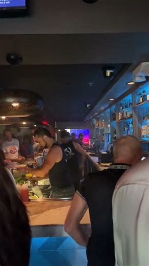 Lively Bar Scene with Bartenders in Action#barscene #nightlife #bartenders #drinks