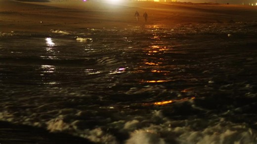 Walking Along the Stormy Atlantic Ocean at Night