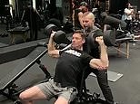 Hugh Jackman shows off his huge biceps as he works out at the gym