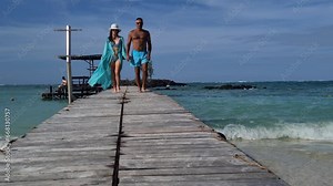 Happy couple walking on tropical beach. Honeymoon love romance and relaxation at resort Stock Video