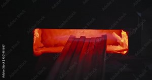 Close up of metal platens forging in furnplace. Precess of creating metalwork in smithy, fireplace burning, radiance from fire spreading. Concept of blacksmithing and forging.