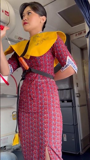 Lion Air flight attendants demonstrate how to use life jackets.