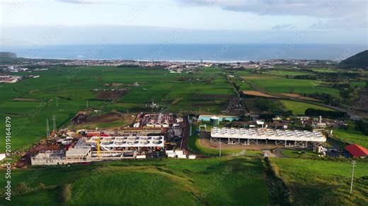 Pico Vermelho Geothermal Plant In Rural Landscape Near The Coast. Sao Miguel Island, Portugal. drone ascend, tilt-down shot