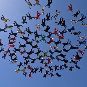 Watch 101 skydivers form record-breaking snowflake formation