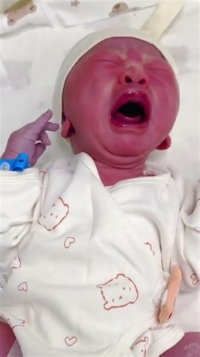 The newborn opened its mouth so wide and started crying loudly