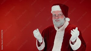 Chest up stab shot of Santa Claus in glasses and traditional red costume looking slyly at camera and throwing up hands, template or copy space Stock Video