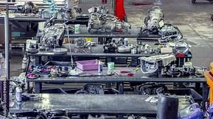 Mechanic's garage with automobile engines being repaired and rebuilt - time lapse