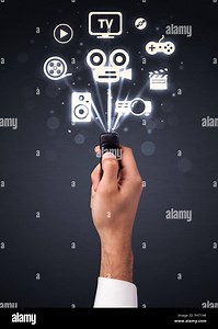 Hand with remote control and media icons Stock Photo - Alamy