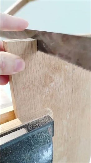 Carpenter Precisely Cutting Wood With A Hand Saw For Furniture