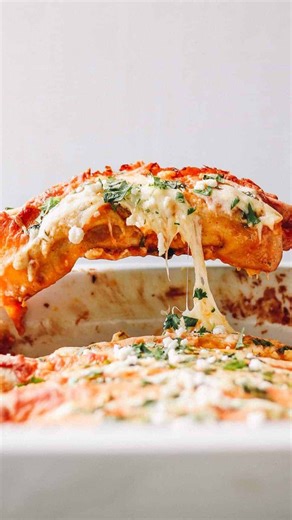 Shredded Chicken Enchiladas RECIPE Ingredients: 2 Tbsp unsalted butter (¼ stick) 2 Tbsp all-purpose flour 10 oz red enchilada sauce (1 can) 1 cup low-sodium chicken broth ½ tsp kosher salt ½ tsp freshly ground black pepper 1 Tbsp canola oil 2 yellow onions, diced 4 oz diced green chiles (1 small can) 1 Tbsp ground cumin 1 tsp chili powder 3 cups shredded cooked chicken 6 oz queso fresco, crumbled 1 cup sour cream (room temperature) 16 oz freshly shredded Monterey Jack cheese (divided) 8 large fl