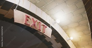 Exit sign on the amusement park arch. Red sign on wooden plate hanging on chains Stock Video