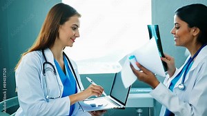 Doctors Analyzing X-ray Film and Prescribing Oncologist Therapy at Hospital