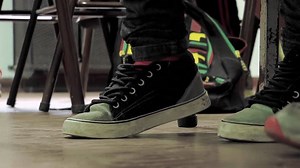 Anxious Student Tapping Feet Under Desk in High School Classroom – 4K Close-Up