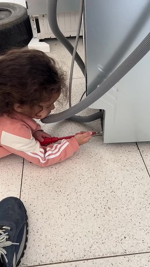 Curly Haired Toddler Explores Household Appliances