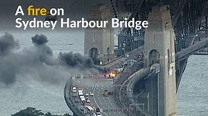 A bus catches fire during peak rush hour on Sydney Harbour Bridge, causing a major traffic jam. Investigators are still determining the cause of the blaze. | Reuters