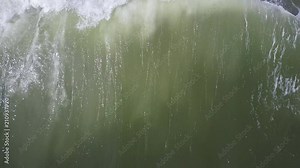 Large wave crashing in the emerald green waters of East Hampton Main Beach