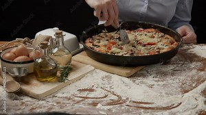 Cutting pizza with a round cutter knife. Close-up of delicious pizza being cut into pieces. slicing a pizza into multiple slices with a pizza cutter. using cutting wheel to slice tasty freshly baked