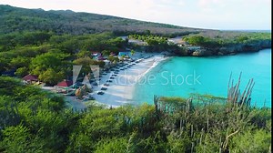 Drone dolly reveal Grote Knip beach Curacao behind shrubland and cactus