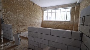 White brick wall added in the room with orange brick room. Large window is in the front wall at backdrop.