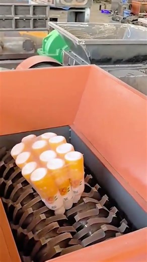 Industrial shredder crushing multiple plastic bottles at once