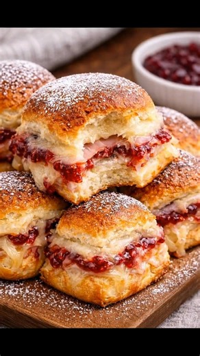 These Monte Cristo Sliders are the ultimate game day treat that will have everyone asking for seconds – they’re like a warm hug in sandwich form! Just beware, once you pop one in your mouth, you won't be able to stop. #montecristo #sliders #gameday #comfortfood #appetizer Full recipe’s in the comment 👇 | Recipes & Cooking Guide