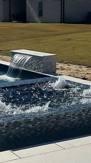 Small, modern, and sleek — a custom luxury pool with a rim-flow spa and a premium travertine pool deck. Designed for high-end outdoor living. #LuxuryPool #ModernPoolDesign #RimFlowSpa #TravertineDeck #HighEndBackyard | TS Campbell Pool Designs