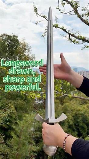 Live-action footage of a Western-style long sword being drawn out of its sheath.