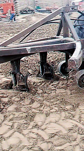 Tractor with Plow in Action: Soil Preparation Process