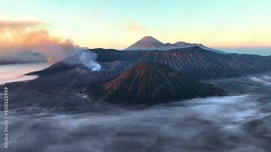 sunrise at Bromo volcano in Indonesia, East Java, adventure tourism in Indonesia, hiking an active volcano, famous Indonesian landmark of Bromo volcano Stock Video