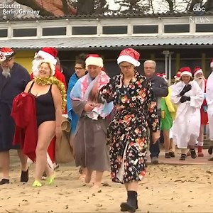 Festive bathers brave the icy temps to take a traditional Christmas dip at Orankesee Lake in Berlin, Germany! | Good Morning America