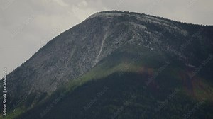 Cloud shadows across a large mountain foreest