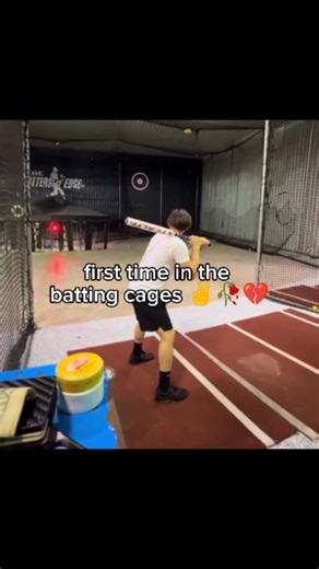 Memes® on Instagram: "This video features, a young man stands in a baseball batting cage, bat in hand, prepared for his first attempt at hitting. A caption on the screen reads "first time in the batting cages," accompanied by a peace sign and a broken heart emoji. As the pitching machine fires, the ball strikes the man squarely in the groin. The impact causes him to double over instantly, dropping the bat and letting out a high-pitched, comical scream as the camera quickly shakes and cuts away."