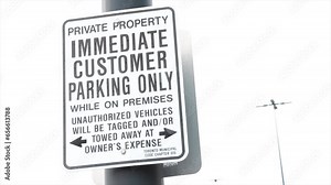 private property immediate customer parking only while on premises tagging and towing consequences black and white rectangle sign exterior outside, left frame
