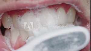 the process of using a toothbrush as a step in the daily procedure of brushing your teeth close-up Stock Video
