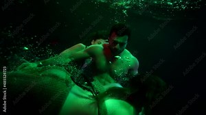water-nymphs are alluring sinking sailor in sea, swimming near him in depth, horror and fantasy shot Stock Video