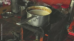 A close-up of tea boiling or tea preparation on the stove at a local tea stall