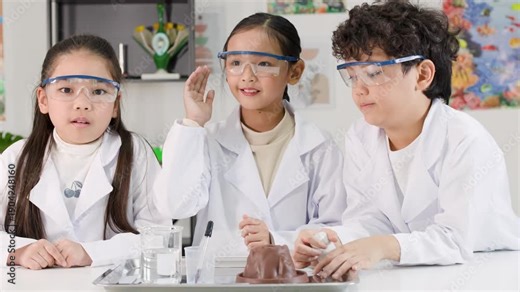 Asian Students in Lab Coats Perform Baking Soda and Vinegar Volcano Experiment