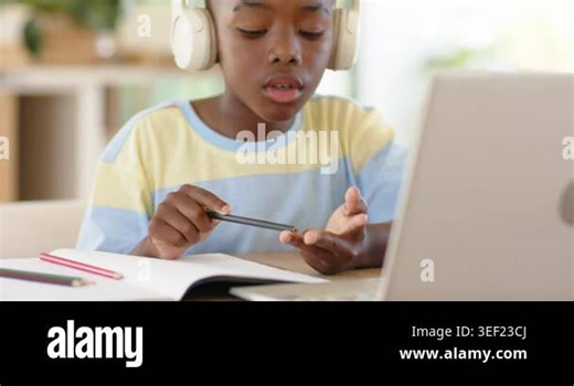 Counting fingertips, African American boy writing homework in notebook with laptop at desk. Study, concentration, creativity, education, youthful, domestic, learning Stock Video Footage - Alamy