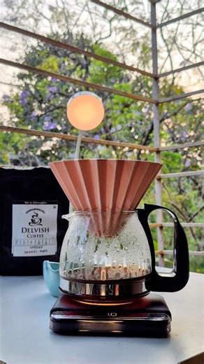 Caffeine Counsel on Instagram: "Brewed Delvish Coffee Roasters Whiskey Barrel Aged Coffee (Medium Roast) in the Origami dripper ☕ This coffee is aged in whiskey barrels, allowing the beans to absorb deep, complex notes without overpowering the natural coffee character. The result is a beautifully balanced cup with oak, vanilla, caramel sweetness, subtle boozy warmth, and a smooth chocolatey finish. Brew details: • 15g coffee • 1:14 ratio • 93°C water • Flat bottom filter paper • Clean, structure