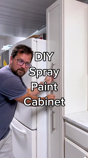DIY spray paint cabinet - a storage solution for small spaces. #diycabinets #spraypaint #garageorganization #garagemakeover #storagecabinet #diy #diyproject #garagegoals #garage #slidingshelves #keepittidy #homeimprovement #diyhomeimprovement #diyhome #garageworkshop