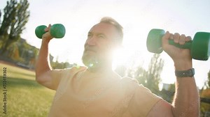 Aged Caucasian European man sportsman lifting dumbbell weightlifting energy training bodycare stadium outdoors physical male equipment flexible concentrated athleticism motion wellness hard sporting Stock Video