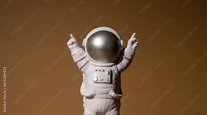 Zoom in out Plastic toy figure astronaut on beige neutral background Copy space. Concept of out of earth travel, private spaceman commercial flights. Space missions and Sustainability