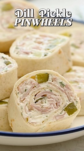 These dill pickle pinwheels are made with cream cheese, fresh dill, ranch seasoning, chopped pickles, and deli ham all rolled snuggly together inside a tortilla and sliced for easy grab-and-go servings. #dillpicklepinwheels #pinwheels #picklepinwheels #picklelover #dillpickles #appetizers #snacks #gamedayfood 🔗 https://amandascookin.com/dill-pickle-pinwheels/ | Things I Love