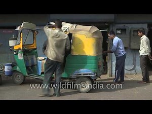 Stitching the yellow cover for an auto rickshaw : good old Make in India