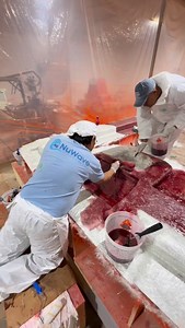 Hand layup in progress by wetting out and placement of fiberglass reinforcement to build thickness, strength, and long-term durability. Each layer is carefully worked to conform to the tool geometry and minimize air entrapment. #NuWaveComposites #HandLayup #FiberglassLaminating #CompositeManufacturing #MarineComposites | NuWave Composites