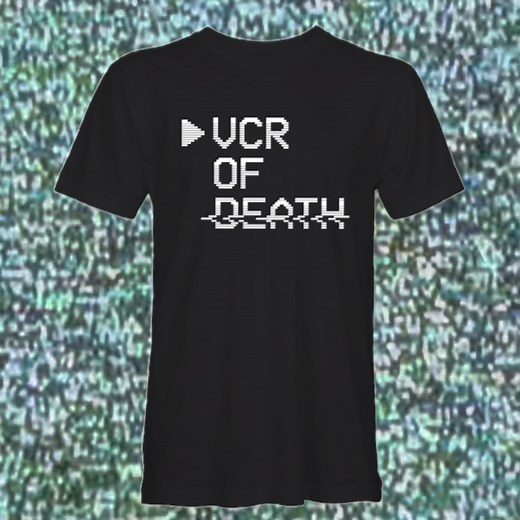 VCR of Death logo tees are now available in my shop. If you’re looking for an easy way to support this page, grab one of these. Wearing one will let everyone around you know that you’re the right person to ask for things like Andy Sidaris reccos, Leprechaun sequel rankings and weak neck movie moments. Shirts are printed by the venerable Mitch’s Prints on Comfort Colors tees. Due to global shipping stupidity, we’re only shipping inside the U.S. right now… but if you live somewhere else, shoot me