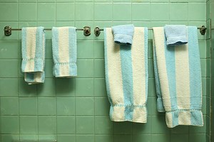 How to Remove a Cemented Towel Rack From a Tile Wall