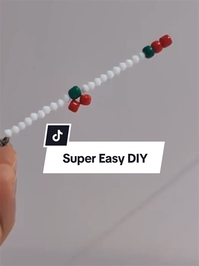 Learn how to make a cute Cherry Bead Bracelet 🍒 In this simple DIY jewelry tutorial, thread 10 white beads, 1 green bead, and 2 red beads to create a cute cherry pattern. Bring the string back through the green bead, tighten, and repeat the pattern to continue the bracelet. To finish the bracelet, I attached a closed O-ring on one end and a lobster clasp on the other side so it’s easy to wear and secure. This is an easy and relaxing beaded bracelet project for beginners, perfect for summer acce