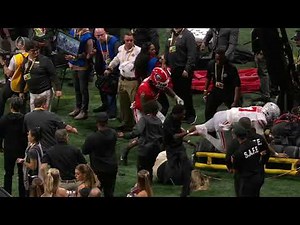 CJ Stroud destroys someone on the sideline then helps her up
